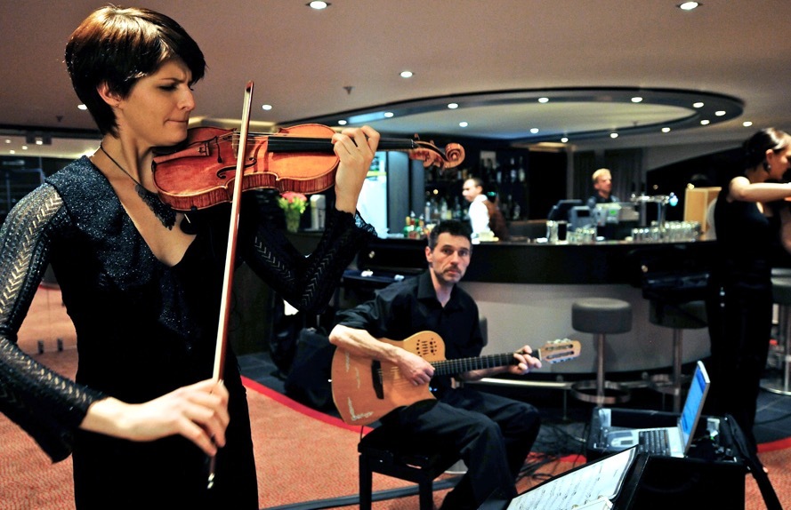 A violinist and guitarist perform aboard an Avalon Waterways river cruising ship